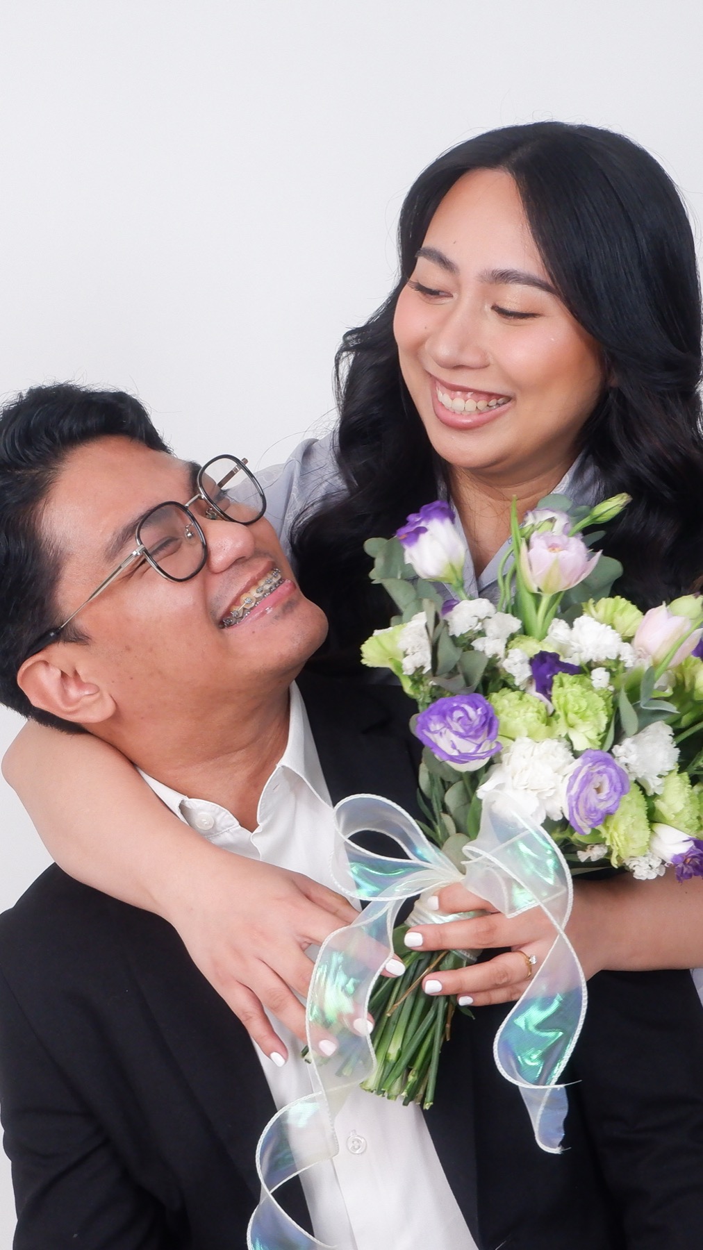 Tope and Anne embracing with a bouquet